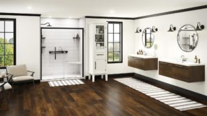 Newly remodeled bathroom with modern aesthetic. Walk-in shower with built-in seating and grab bars. Twin sinks. Off-white walls with black trim around ceiling