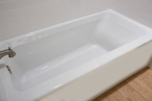 A close view of newly installed white bathtub in bathroom