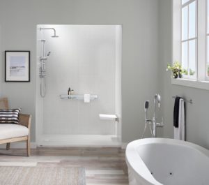 White tile shower newly installed in light gray bathroom with stainless steel hardware and light wood flooring