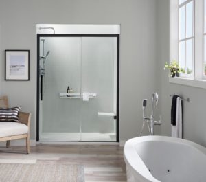 A modern bathroom with flooring and new white bathtub installed in a corner